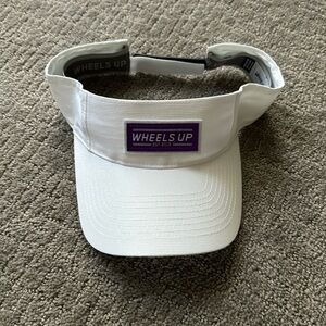 White visor with purple “wheels up” logo